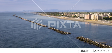 Panorama of italian sandy beaches with umbrellas and gazebos at sunny day Panorama of italian sandy beaches with umbrellas and gazebos at sunny day 127499827