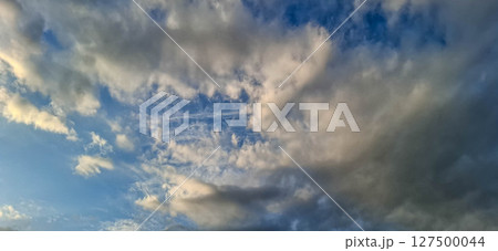 Evening sky with yellowish-gray clouds. Evening sky with yellowish-gray clouds. 127500044
