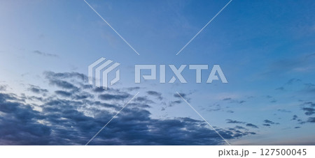 Evening sky with yellowish-gray clouds. 127500045