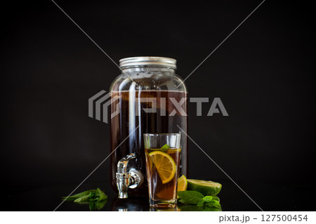 Homemade kombucha starter with kombucha on a black background Homemade kombucha starter with kombucha on a black background 127500454