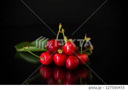 harvest of sweet red cherries on black background 127500455