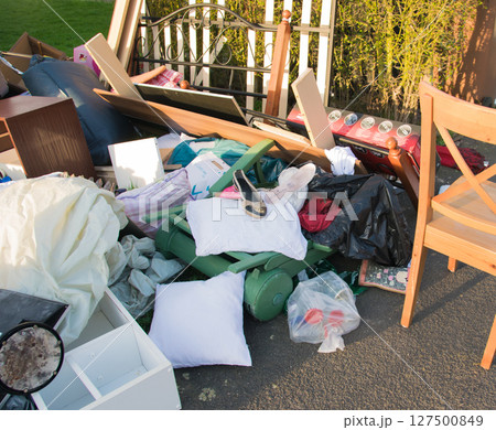 Waste in a city near the house. Big garbage with old wood furniture, toys, boxes, plastic bags on a street and green grass in spring sunny trash dump day in Germany. Waste in a city near the house. Big garbage with old wood furniture, toys, boxes, plastic bags on a street and green grass in spring sunny trash dump day in Germany. 127500849