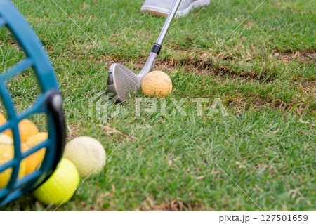 Engaging in Golf Practice Perfecting Your Swing with an Iron at the Driving Range Engaging in Golf Practice Perfecting Your Swing with an Iron at the Driving Range 127501659