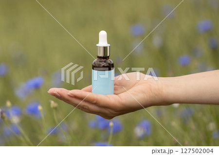 Dropper Bottle Mockup Held in Natural Setting Dropper Bottle Mockup Held in Natural Setting 127502004