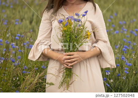 Woman Holding Wild Herbal Bouquet in Meadow Woman Holding Wild Herbal Bouquet in Meadow 127502048