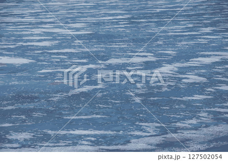 Vector illustration of Winter nature background with blocks of ice on frozen water in spring. Abstract background of drifting ice on water. 127502054