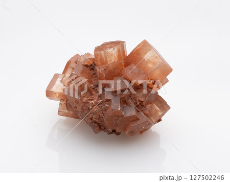 Natural Aragonite Crystal Formation: Warm Orange Geometric Mineral Specimen, Textured Cubic Structure, Isolated Studio Shot on White Background Natural Aragonite Crystal Formation: Warm Orange Geometric Mineral Specimen, Textured Cubic Structure, Isolated Studio Shot on White Background 127502246