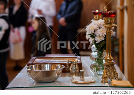 Orthodox Christian Baptism Ceremony with Candles and Holy Water Basin at Church Altar, Golden Details, Spiritual Ritual Orthodox Christian Baptism Ceremony with Candles and Holy Water Basin at Church Altar, Golden Details, Spiritual Ritual 127502269