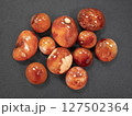 Radiant Carnelian stones on a deep dark surface. Concept of energy, vitality and protection 127502364