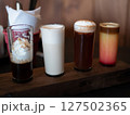 Assorted coffee beverages on wooden plank. Variety of gourmet coffee styles 127502365
