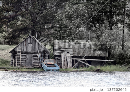 wooden house, barn of fisherman, motor boat 127502643