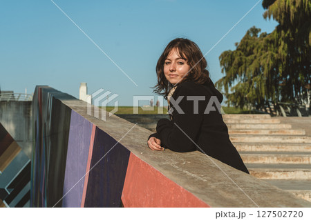 Portrait of smiling woman behind a painted colorful wall Portrait of smiling woman behind a painted colorful wall 127502720