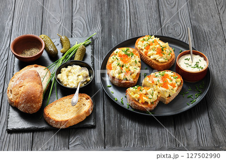deviled egg salad and red caviar on toast deviled egg salad and red caviar on toast 127502990