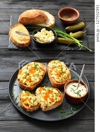 deviled egg salad and red caviar on toast deviled egg salad and red caviar on toast 127502991