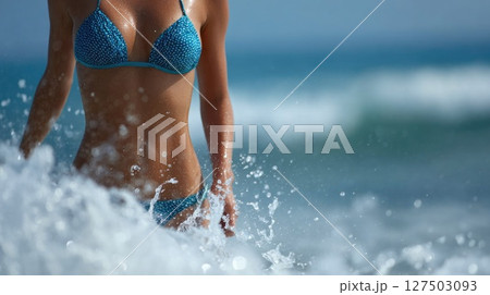 Woman in Polka Dot Bikini Splashing at Sea 127503093