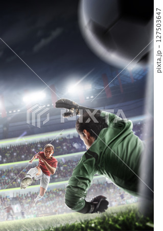 Goal. A football player scores a goal in a match. The goalkeeper misses the ball. The final match in an arena full of cheering fans. Sports. Vertical 127503647