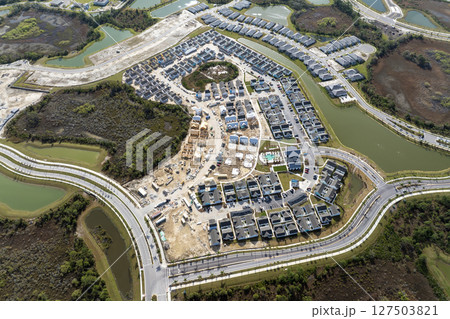 Development of residential housing in the USA. Wooden frames of new cheap American homes under construction 127503821