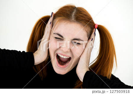 Close up portrait of pretty redhead teenage girl shouting like crazy. Close up portrait of pretty redhead teenage girl shouting like crazy. 127503918