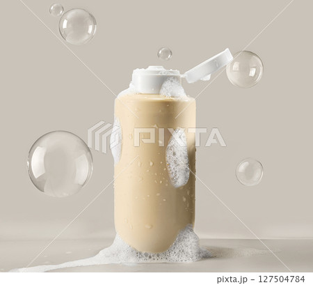 A beige flesh cosmetic bottle with shampoo or shower gel, surrounded by flying bubbles 127504784