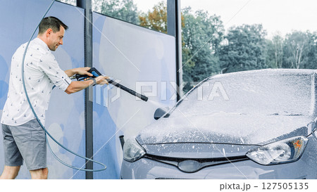 Car wash bubbles. Soap foam water splash. Vehicle spray wet shiny exterior. 127505135