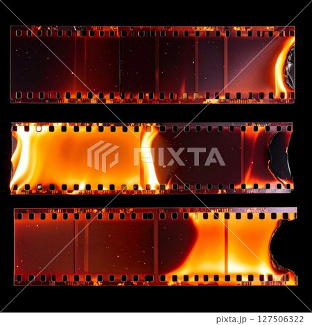 Burning Film Strips on Black Background 127506322