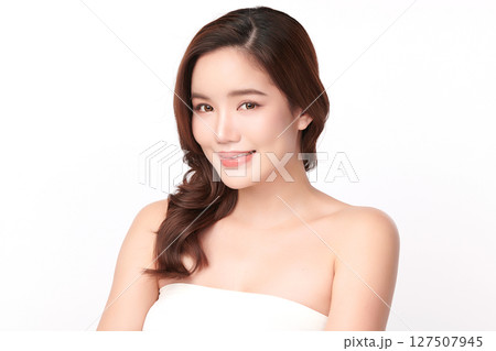 A beautiful young Asian woman with clean, fresh skin against a white background. Skincare, facial treatment, cosmetology, beauty, and spa. An elegant portrait of an Asian woman. 127507945