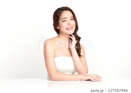 A beautiful young Asian woman with clean, fresh skin against a white background. Skincare, facial treatment, cosmetology, beauty, and spa. An elegant portrait of an Asian woman. A beautiful young Asian woman with clean, fresh skin against a white background. Skincare, facial treatment, cosmetology, beauty, and spa. An elegant portrait of an Asian woman. 127507946