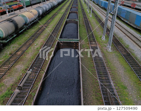 numerous coal wagons line railway tracks efficient transportation infrastructure in industrial area. 127509490