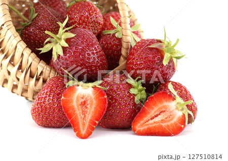 Fresh strawberries spilling from wicker basket on white background Fresh strawberries spilling from wicker basket on white background 127510814