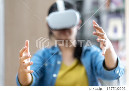 Young Woman Exploring Virtual Reality in Library Young Woman Exploring Virtual Reality in Library 127510991