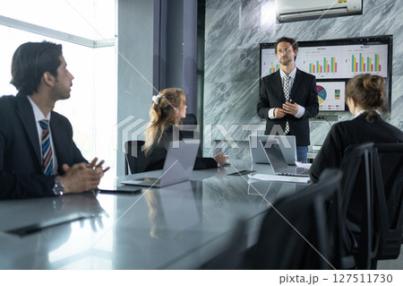 Business Presentation Showcases Market Analysis and Growth Strategies in a Modern Conference Room With Engaged Team Members 127511730