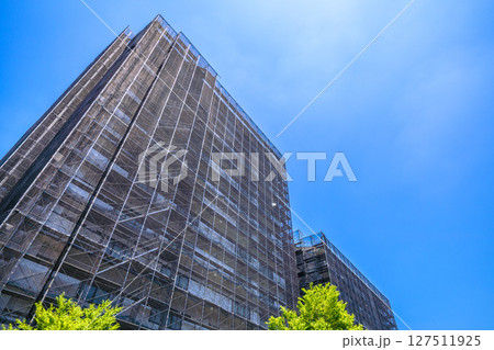 日本の横浜都市景観　マンションの補修や点検等、足場や防護ネットなど。ネットの外に衛星アンテナが… 127511925