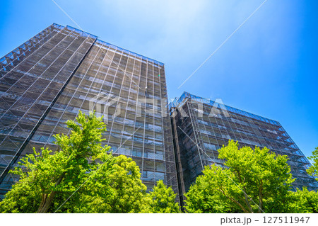 日本の横浜都市景観　マンションの補修や点検等、足場や防護ネットなど。ネットの外に衛星アンテナが… 127511947