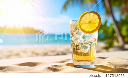 Enjoy a refreshing, cold beverage, whether it's a tropical cocktail, sparkling champagne, or cool water, on a summer beach 127512033