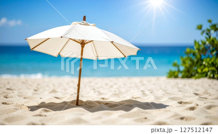 Tropical beach , umbrella, and clear blue ocean under a sunny sky Tropical beach , umbrella, and clear blue ocean under a sunny sky 127512147
