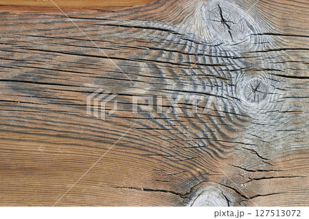 beautiful beige weathered cracked wood decking texture with knots 127513072