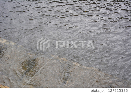 側溝から溢れ出る雨水 127515586
