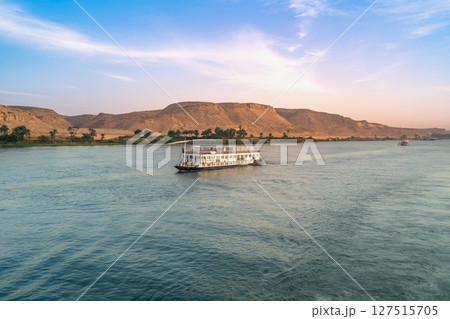 Serene Nile River Cruise at Dusk Near Esna Lock Aswan Egypt. Serene Nile River Cruise at Dusk Near Esna Lock Aswan Egypt. 127515705