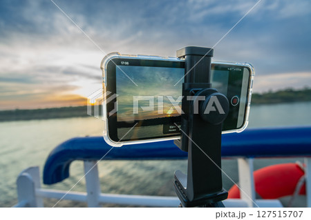 Capturing Nile River Sunset on a Cruise Near Esna Lock Aswan Egypt. Capturing Nile River Sunset on a Cruise Near Esna Lock Aswan Egypt. 127515707