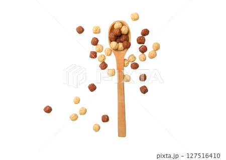 Artful cereal balls by a spoon, isolated on white 127516410