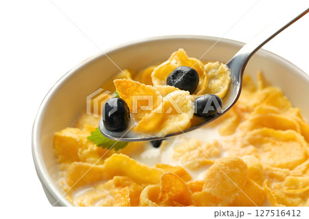 Cornflakes topped with blueberries in a bowl, isolated on white Cornflakes topped with blueberries in a bowl, isolated on white 127516412