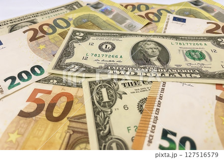 Euro and Dollar Banknotes Close-Up.Euro and US dollar bills together, symbolizing global finance, wealth, and international currency exchange. 127516579