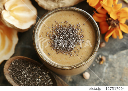 Homemade smoothie with chia seeds in a glass, top view. Healthy and tasty food concept. Homemade smoothie with chia seeds in a glass, top view. Healthy and tasty food concept. 127517094