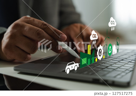 Business sustainability image shows person using stylus digital tablet with various eco friendly and technology icons floating above 127517275