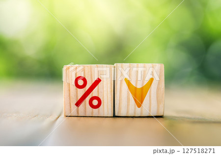 Interest rate financial and mortgage rates concept. Wooden cube block with interest rate and down arrow. 127518271