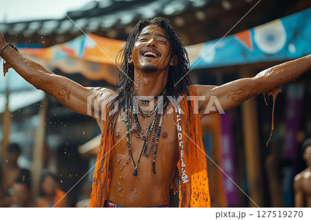 a performer at Boryeong Mud Festival, entertaining a crowd with a mud themed costume and energetic dance 127519270