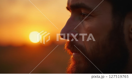 Golden sunset reflection on contemplative man 127519765