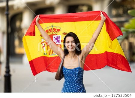 Young woman with spanish flag on city street Young woman with spanish flag on city street 127523504