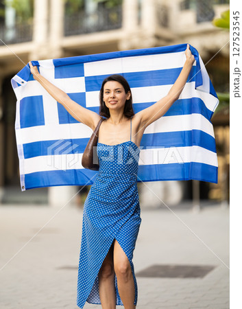 Young woman with Greek flag on city street Young woman with Greek flag on city street 127523545