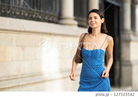 Young woman posing on city street 127523582